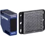 Fotoelektriskais sensors APC XUK1ARCNL2H61 — zils plastmasas korpuss, 0–7 m diapazons, 24–240 V maiņstrāvas ieeja, 250 V izeja, 50×50×18 mm
