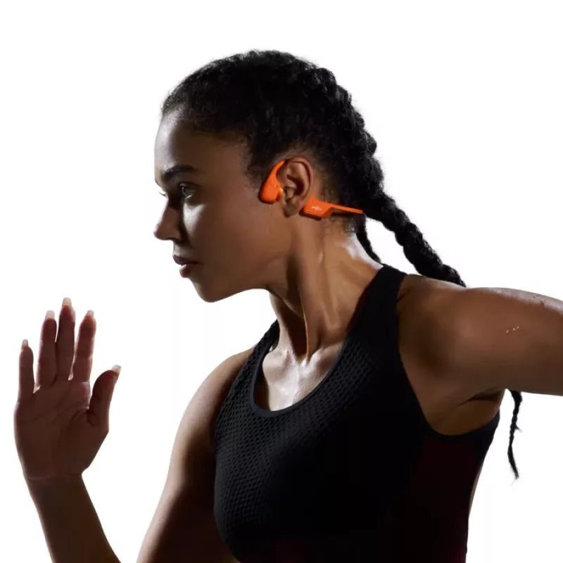 Kaulu vadītspējas austiņas Shokz OpenRun Pro 2 — binaurālas, bezvadu Bluetooth 5.3, IP55, 12 st. darbības laiks, 150 mAh, oranžas, aiz auss stiprināmas