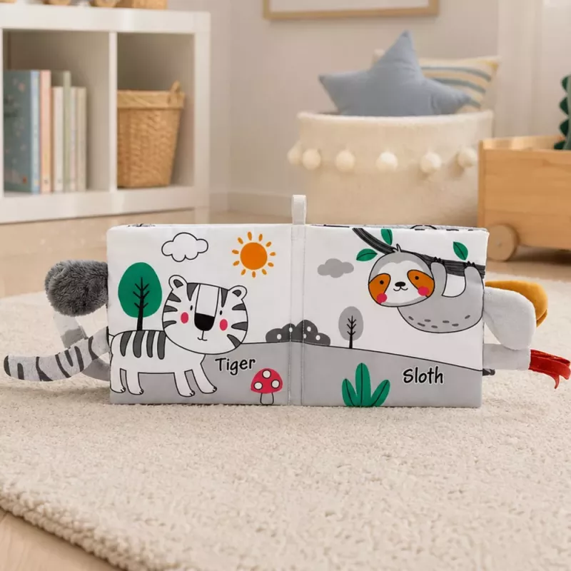 LEAN TOYS Mīkstā sensoriskā grāmatiņa ar šalkojošu un čīkstošu ziloni, pelēka