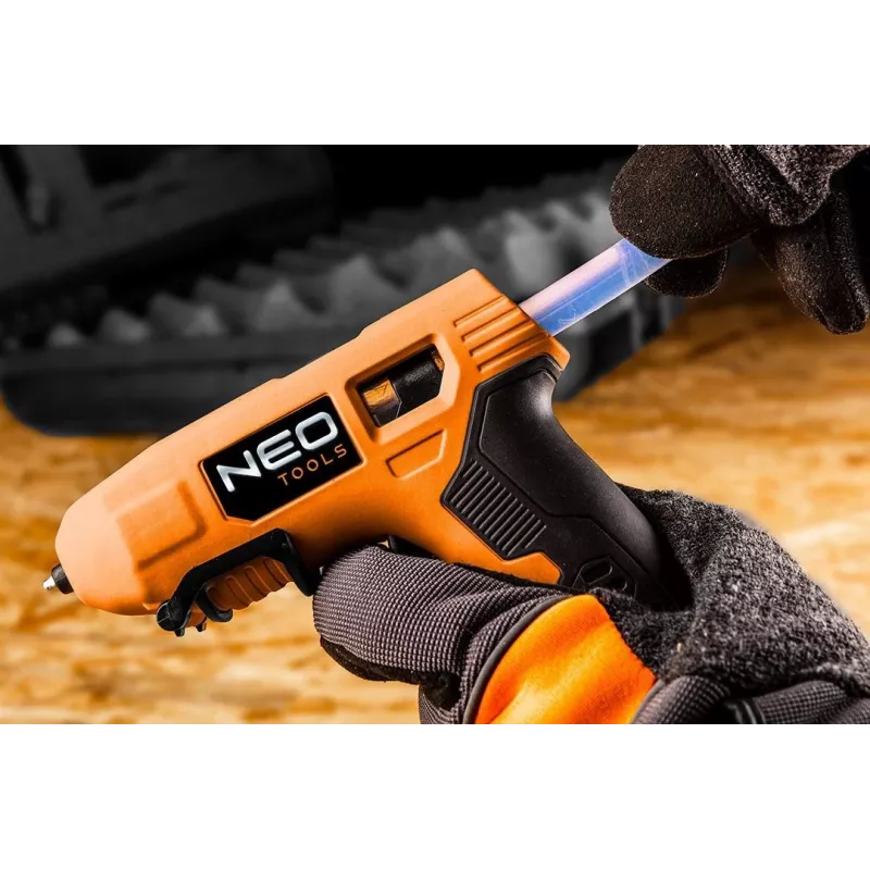 NEO Tools 17-083 20W vada karstās līmes pistole ar pretpilēšanas uzgali, 11mm līmes stienīšiem, integrētu statīvu, 230V, oranža/melna